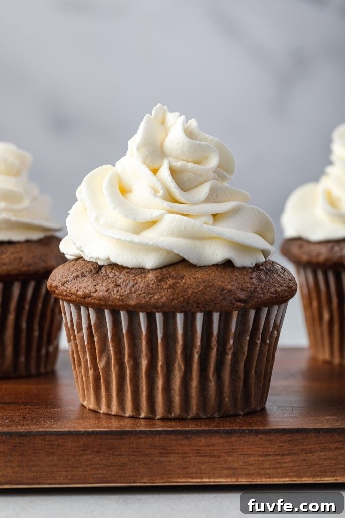 Stabilized whipped cream piped on top of a cupcake