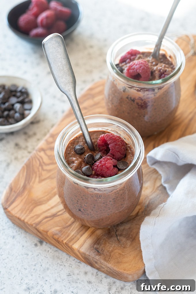 Decadent Chocolate Chia Seed Pudding Recipe 8 Jars of chocolate chia seed pudding with spoons digging in