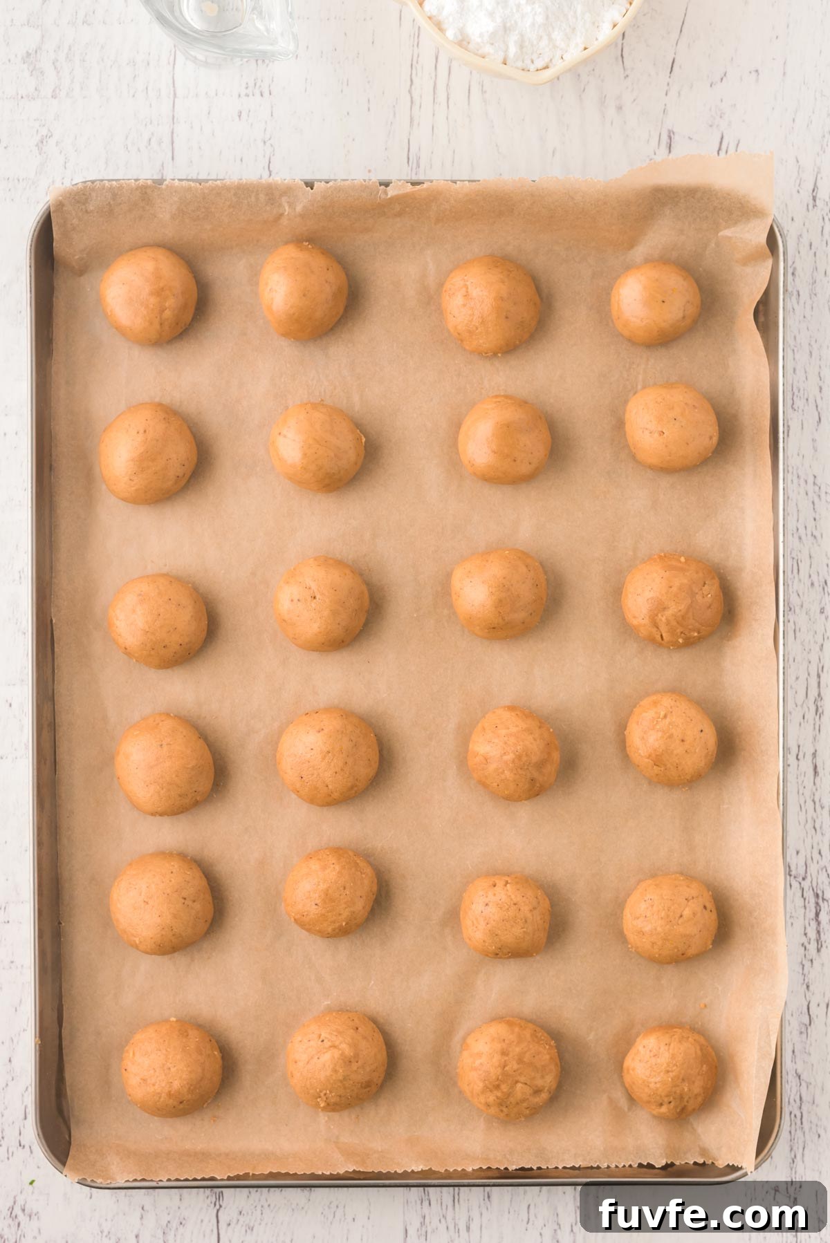 Overhead photo of spice cookies on a parchment lined baking sheet.