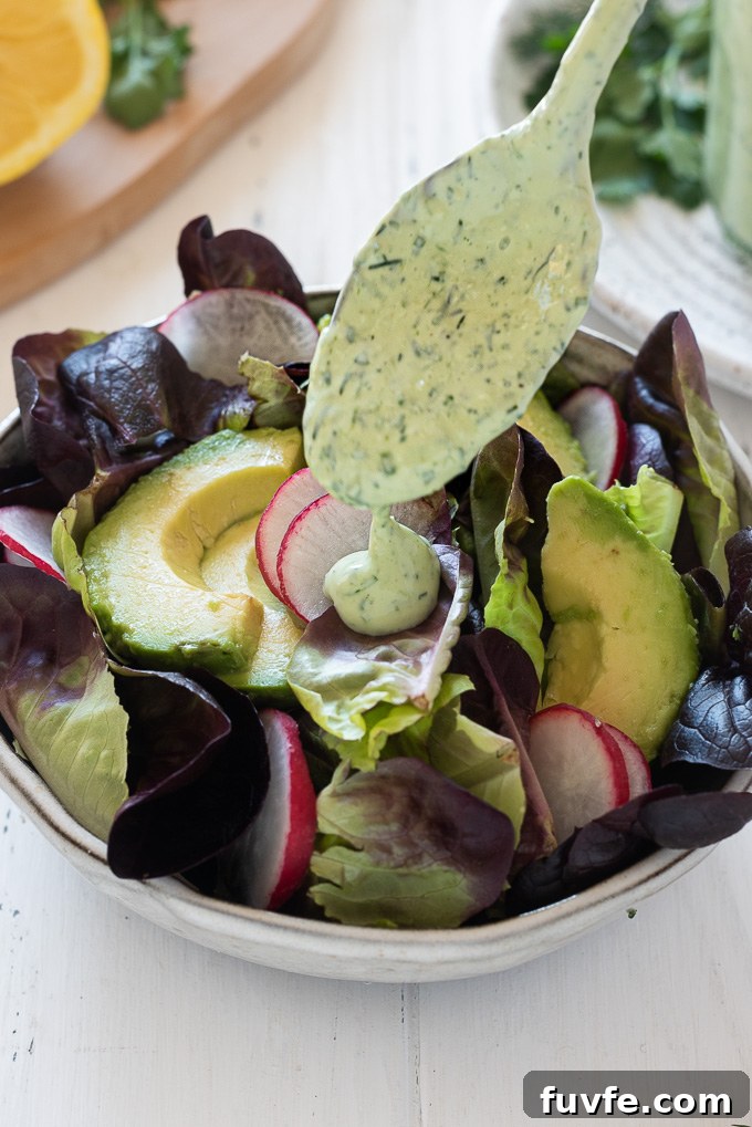 Green goddess dressing drizzling onto a salad