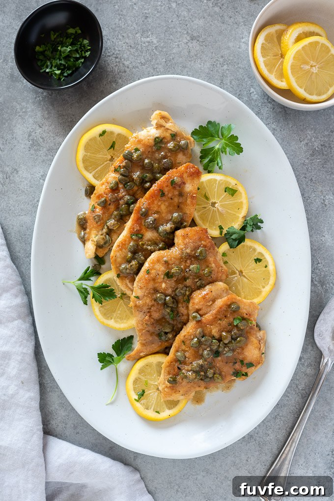 Weeknight Chicken Piccata Recipe with Lemon Caper Sauce 3 Chicken piccata on a white serving platter
