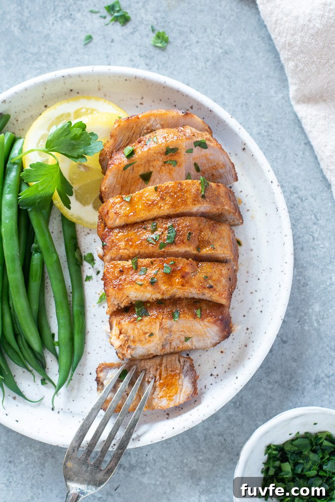 Crispy, Juicy Air Fryer Pork Chops 6 Air fryer Boneless pork chop sliced on a plate