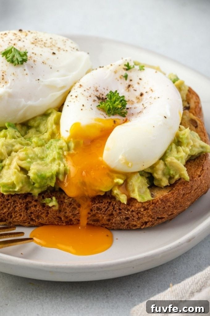 Poached eggs on avocado toast with yolk running