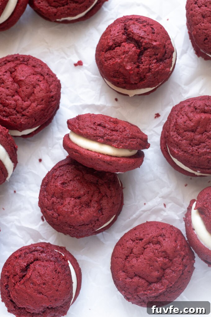 Red velvet whoopie pies on parchment paper.