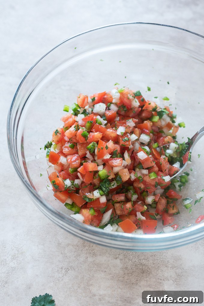 Pico de gallo in a mixing bowl