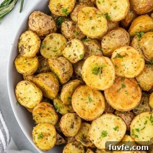 Crispy Air Fryer Potatoes with Garlic and Herbs 7 Air fryer potatoes in a bowl with rosemary