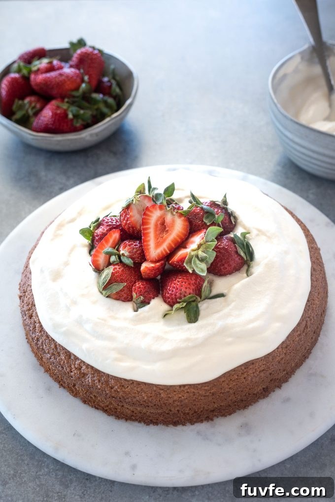Gluten-Free Almond Flour Cake Recipe 2 Almond flour cake topped with strawberries and whipped cream