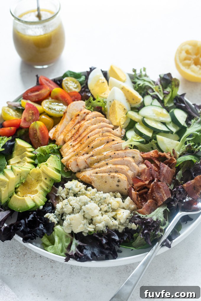 Classic Chicken Cobb Salad Recipe with Avocado and Bacon 3 Cobb salad with chicken in a white bowl