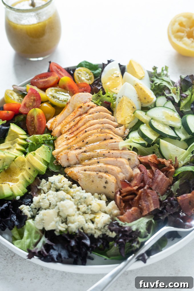 Classic Chicken Cobb Salad Recipe with Avocado and Bacon 7 Cobb salad with chicken in large white bowl