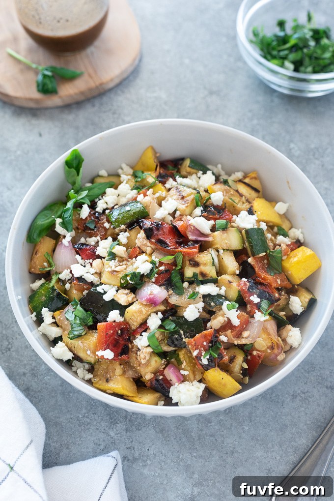 Grilled Vegetable Salad with Balsamic Herb Vinaigrette 3 Grilled vegetable salad with feta in a white serving bowl