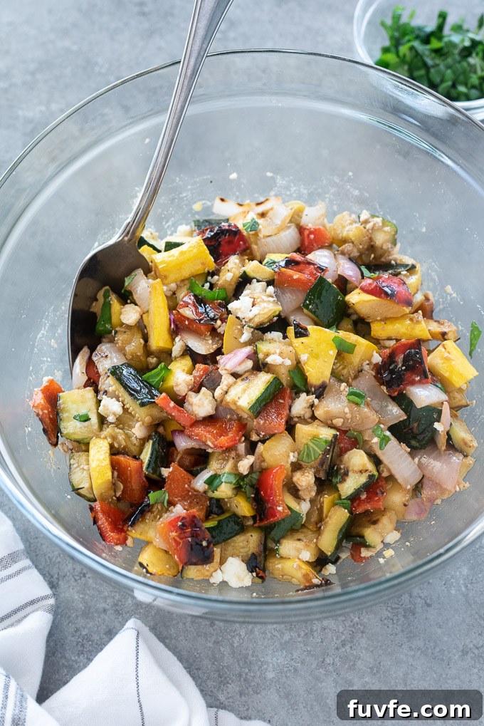 Grilled Vegetable Salad with Balsamic Herb Vinaigrette 6 Grilled vegetable salad in a mixing bowl with a serving spoon