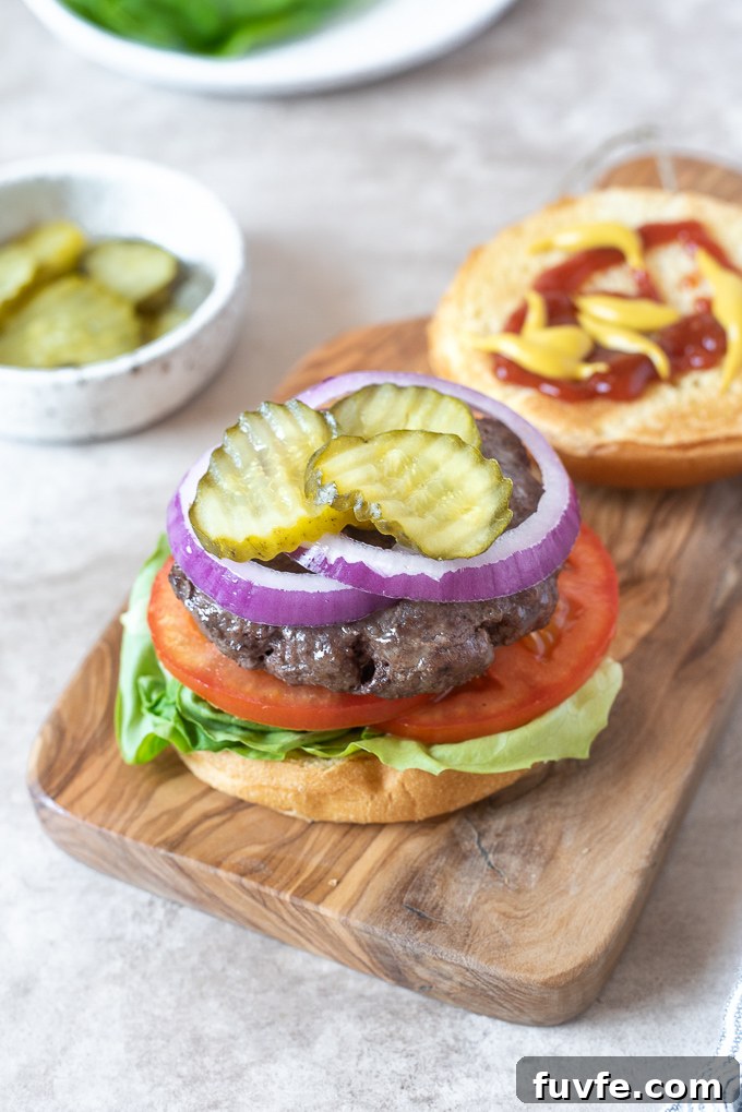 Air fryer hamburger with top bun off to expose toppings