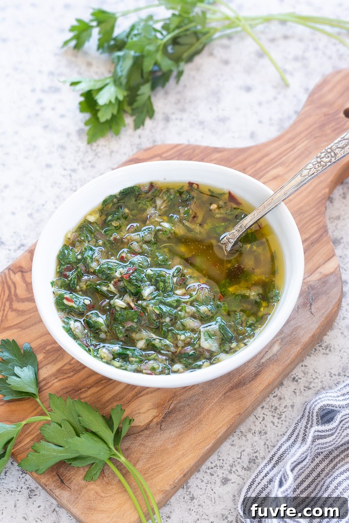Chimichurri sauce in a bowl on a cutting board