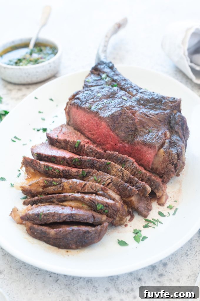 Grilled Tomahawk Steak sliced on a platter