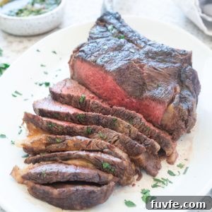 Grilled Tomahawk Steak sliced on a platter