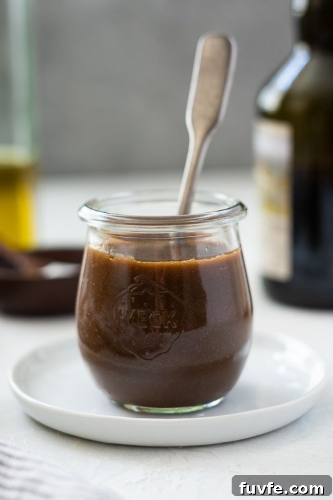 Jar of balsamic vinaigrette with a spoon in it