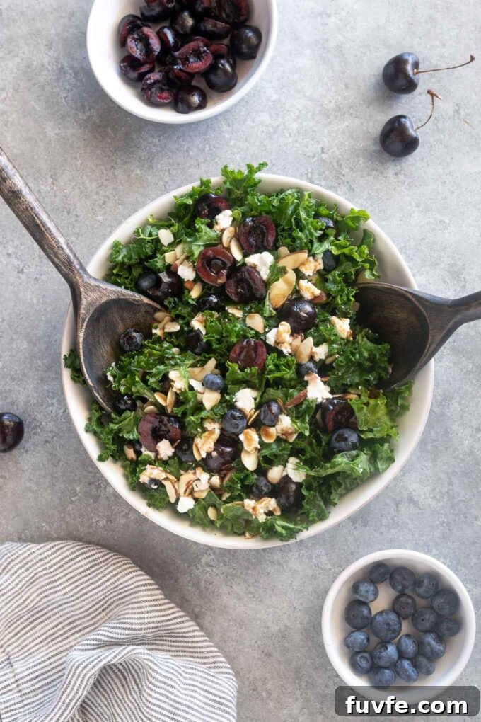 Cherry salad with salad servers digging into the bowl