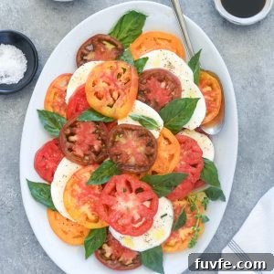 Classic Caprese Salad with Fresh Mozzarella and Balsamic Glaze 9 Caprese salad on a white platter