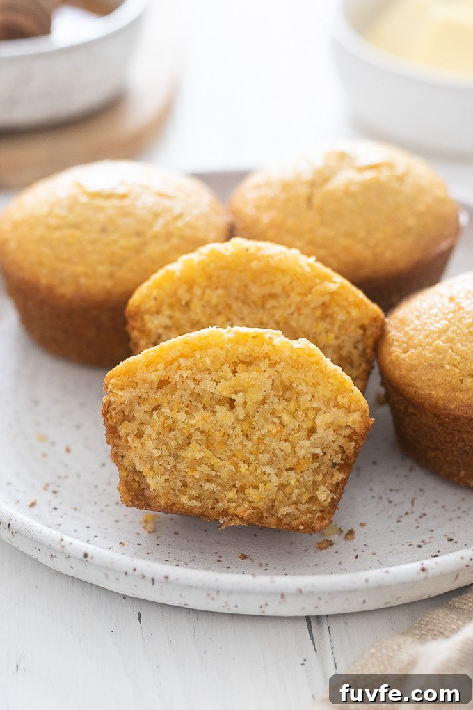 Fluffy Honey Cornbread Muffins Recipe 7 Honey cornbread muffins on a plate