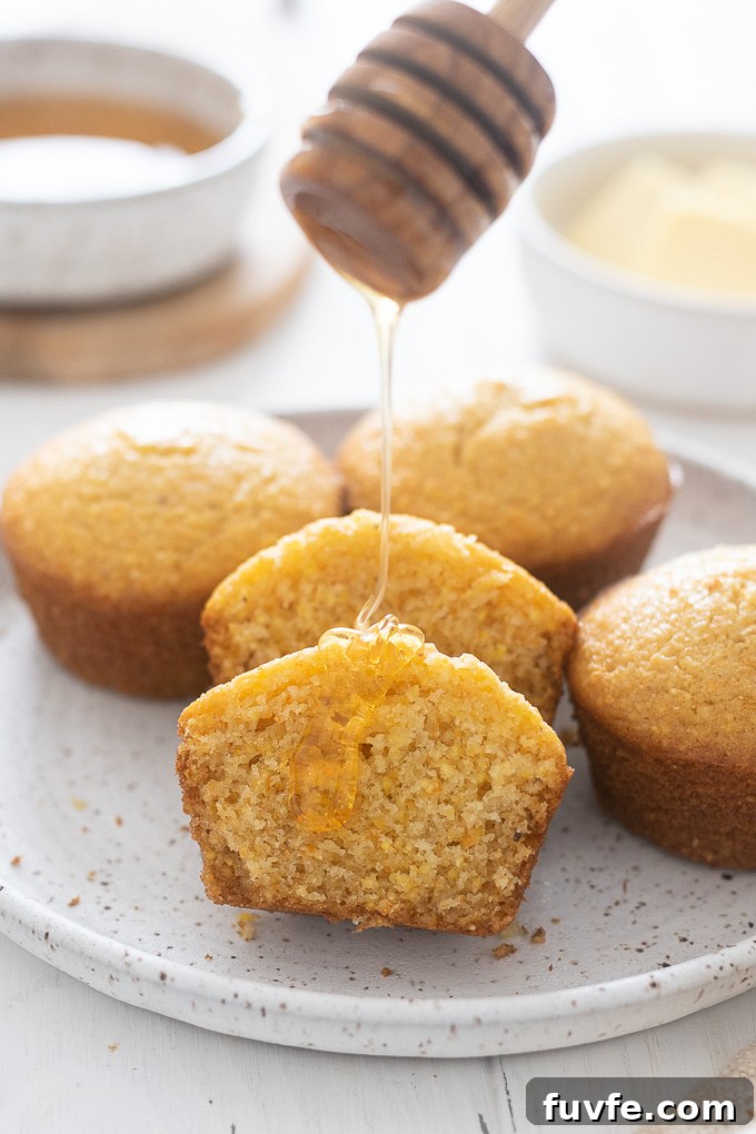 Honey drizzling over a corn muffin