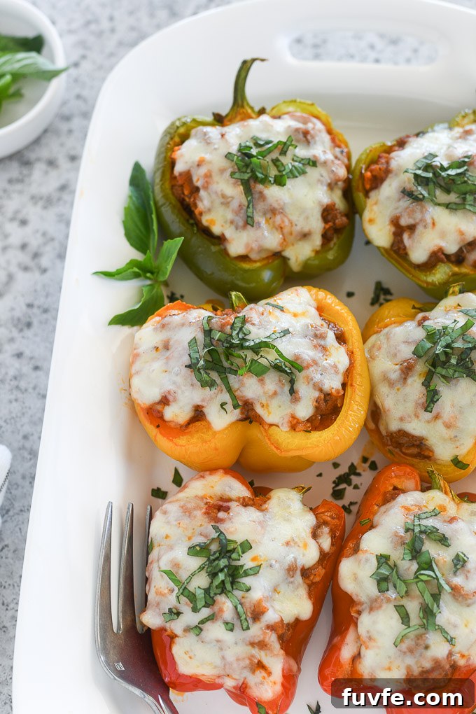 How to Make Classic Italian Stuffed Peppers 7 Italian stuffed peppers on a serving platter with basil