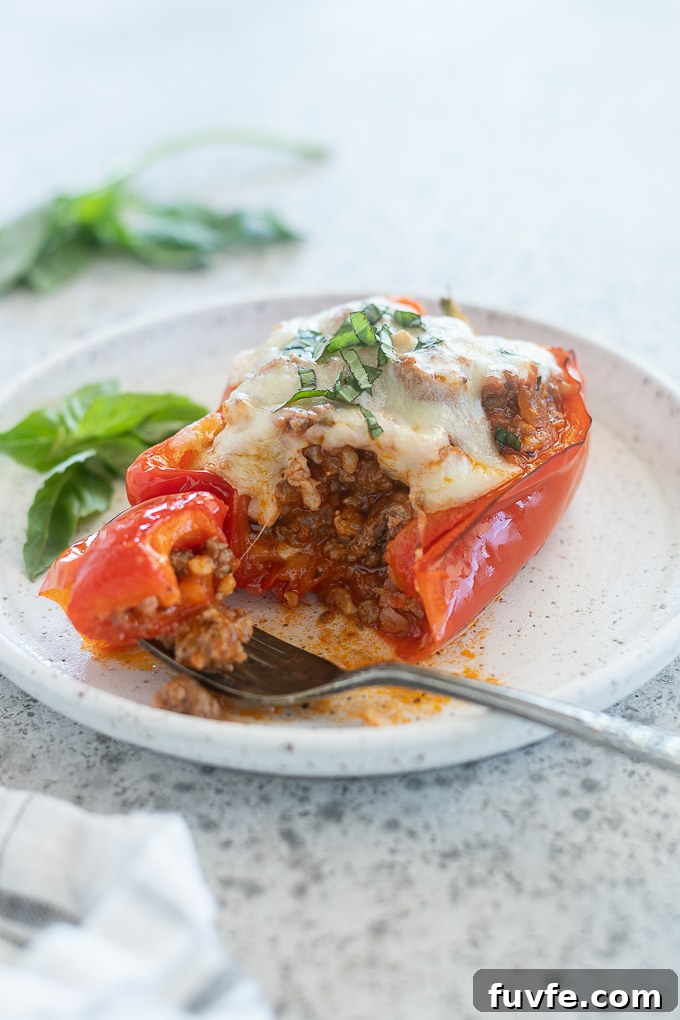 How to Make Classic Italian Stuffed Peppers 8 Fork cutting into a stuffed bell pepper