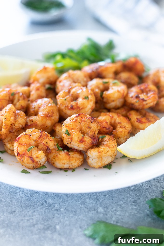 Air fryer shrimp piled on a white plate