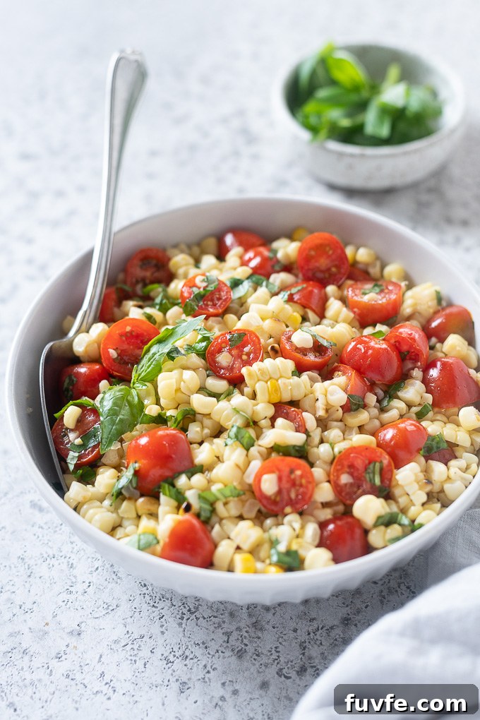 Corn tomato salad in a bowl with basil