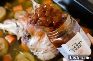 A spoon of real ale chutney coming out a jar of the cherry tree chutney