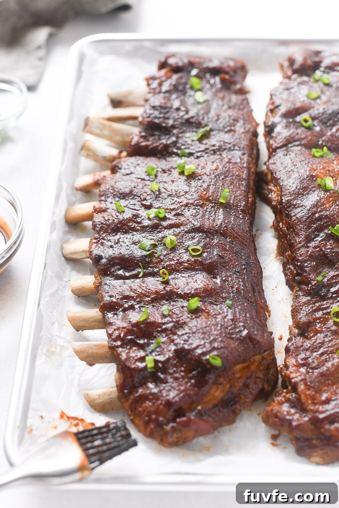 Racks of instant pot pork ribs on baking sheet