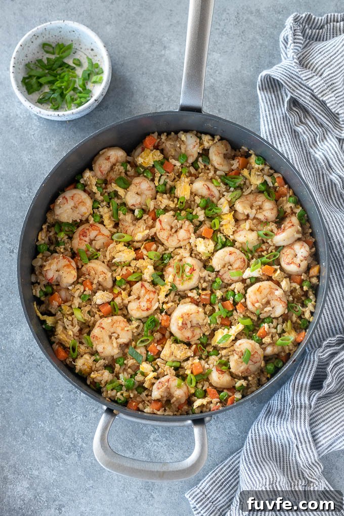 Pan of shrimp fried rice with scallions