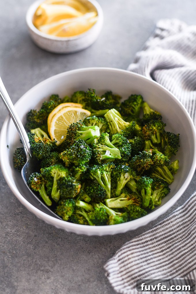 Spoon in bowl of air fryer broccoli
