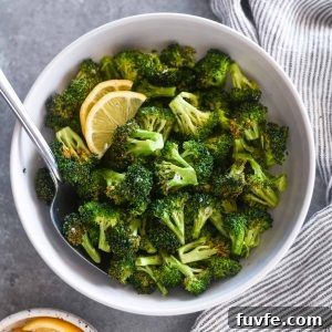 Serving spoon buried in a bowl of air fryer broccoli
