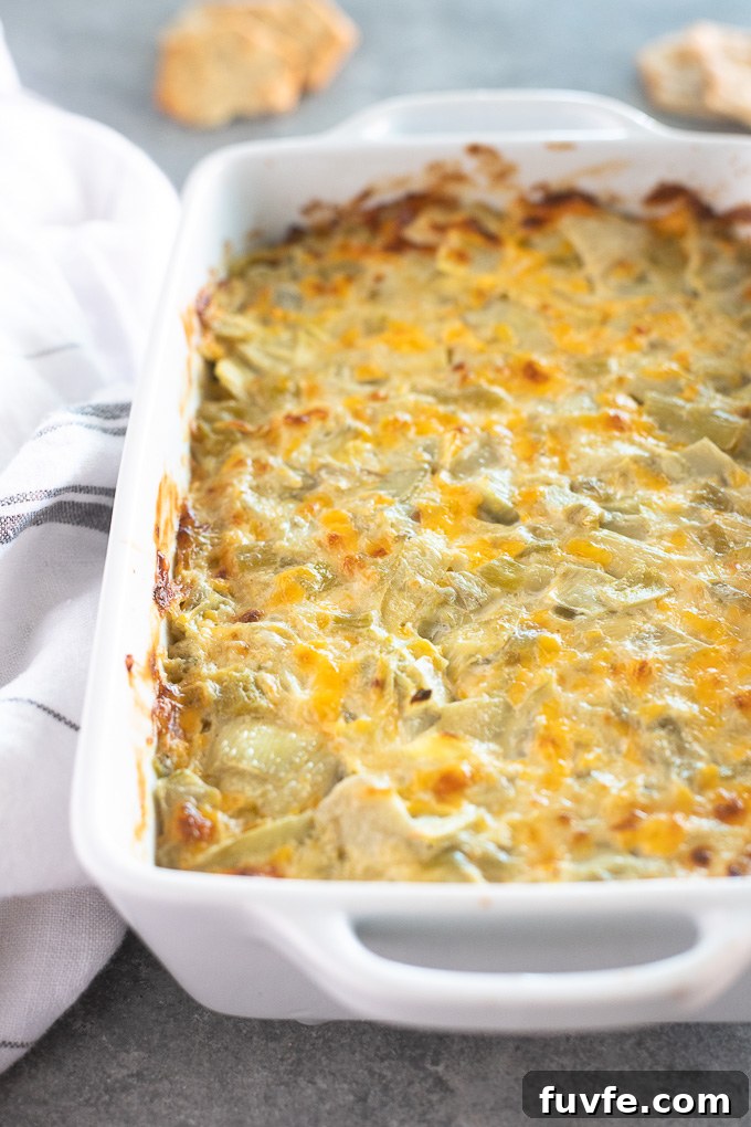 Hot artichoke dip in a white baking dish