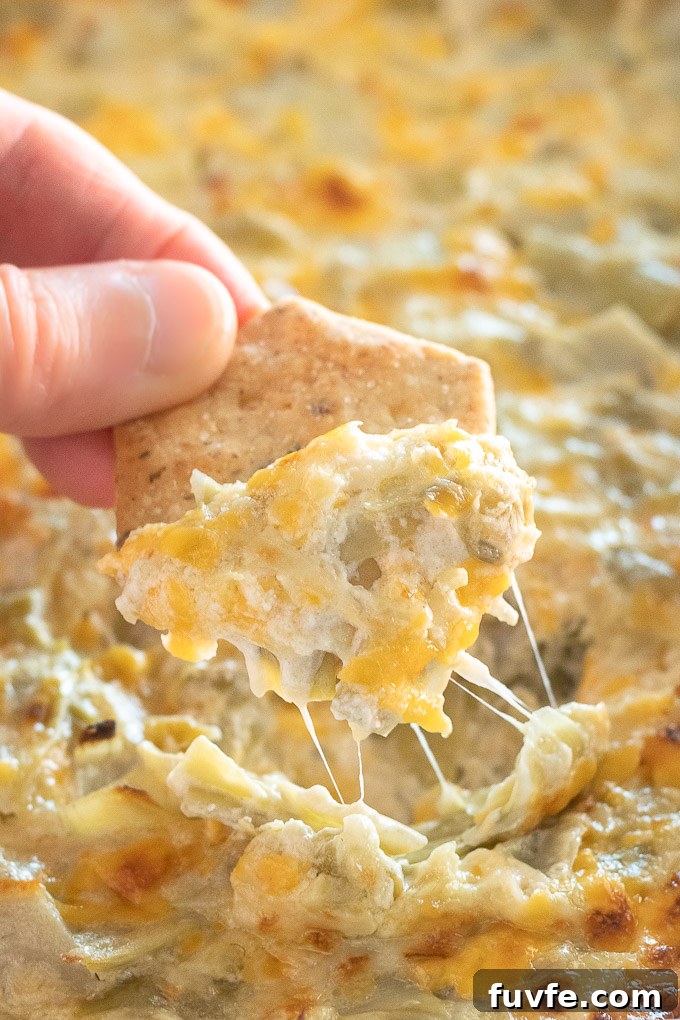 Cracker covered with artichoke dip