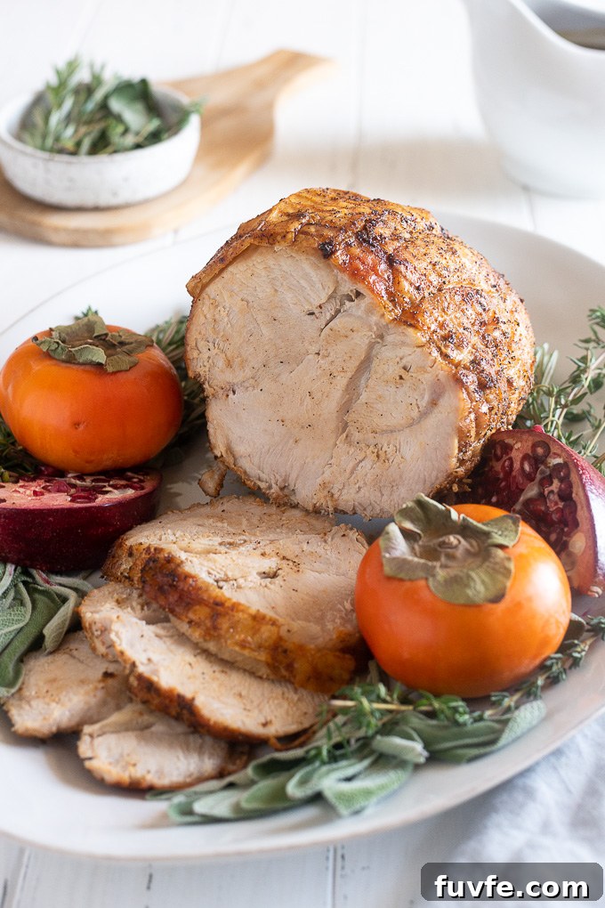How to Roast a Juicy Boneless Turkey Breast 3 Turkey breast roast on a platter with herbs and fruit