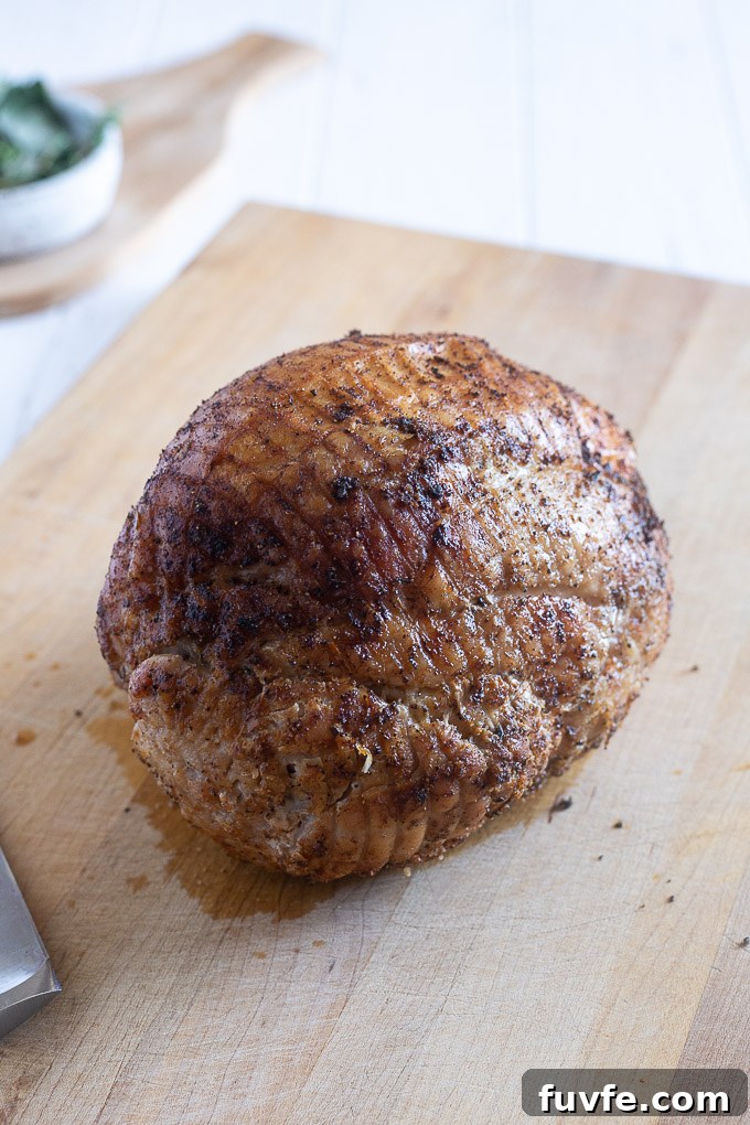 How to Roast a Juicy Boneless Turkey Breast 6 Roasted boneless turkey breast on a cutting board