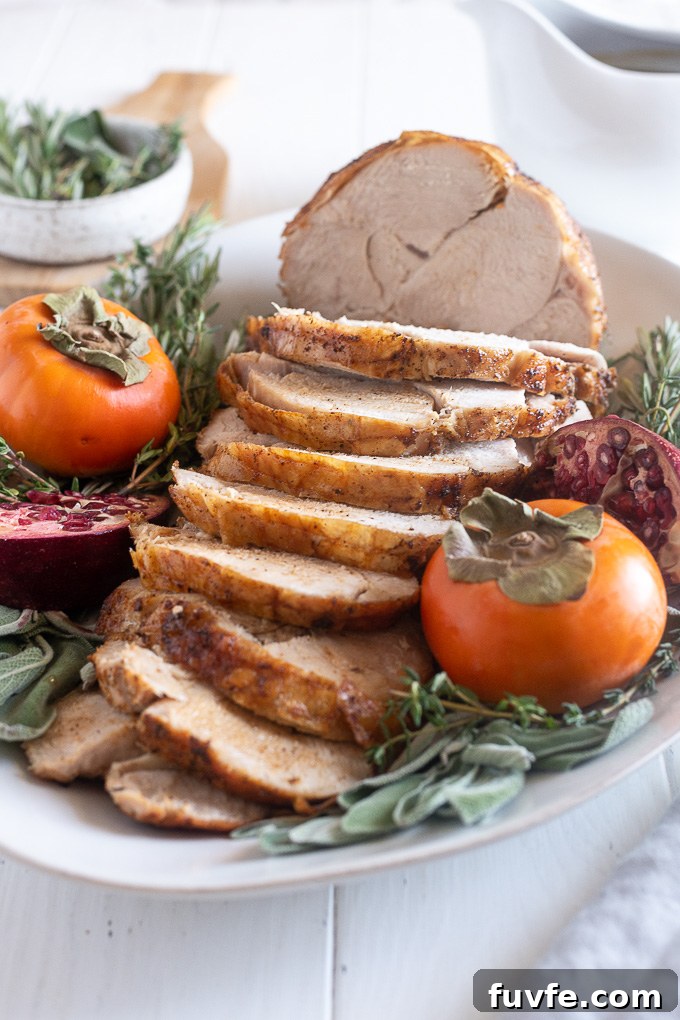 How to Roast a Juicy Boneless Turkey Breast 7 Sliced boneless turkey breast on a white platter