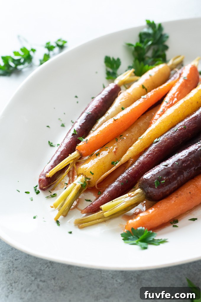 Maple glazed carrots on platter in a pool of glaze