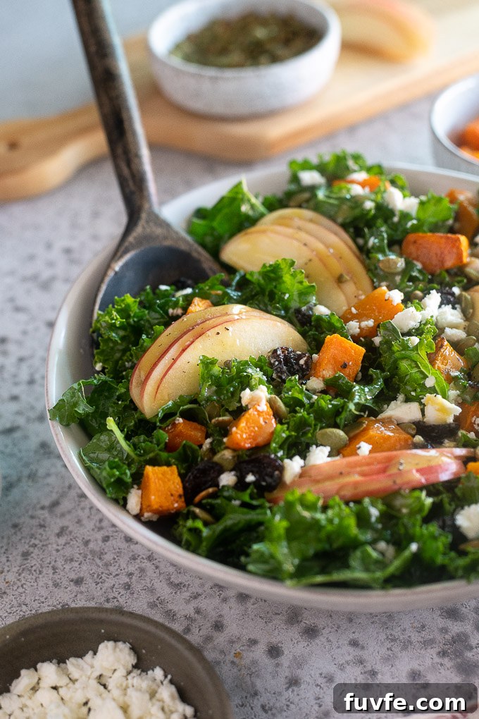 Salad server digging into fall harvest salad