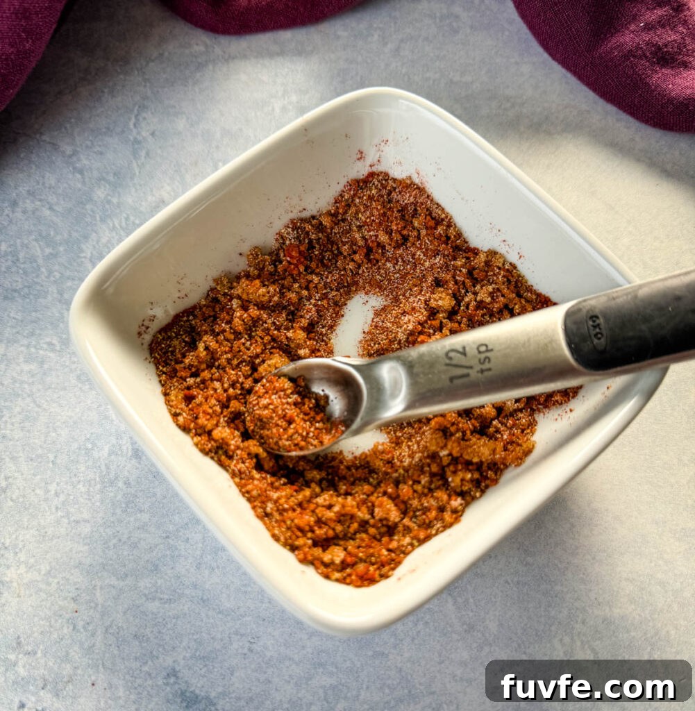 spices for rib dry rub in a white bowl with a spoon