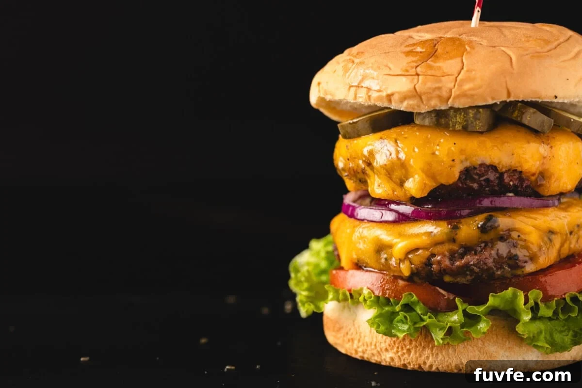 Assembled burger on black background.