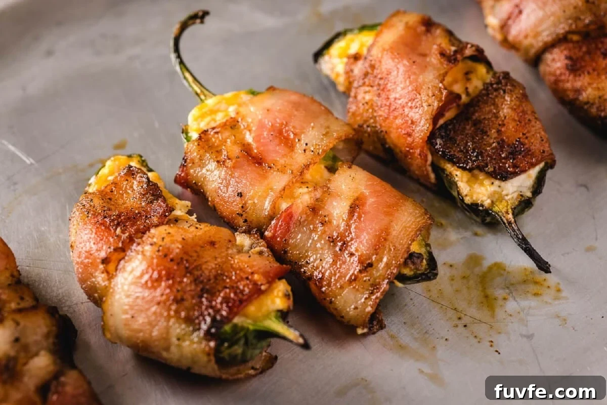 Grilled jalapeño poppers on plate.