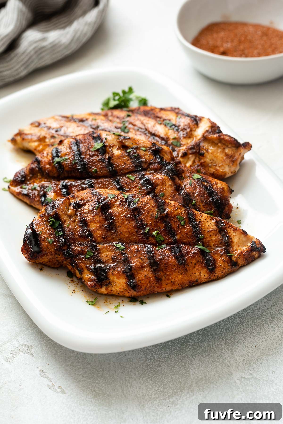 Grilled chicken breast on white plate