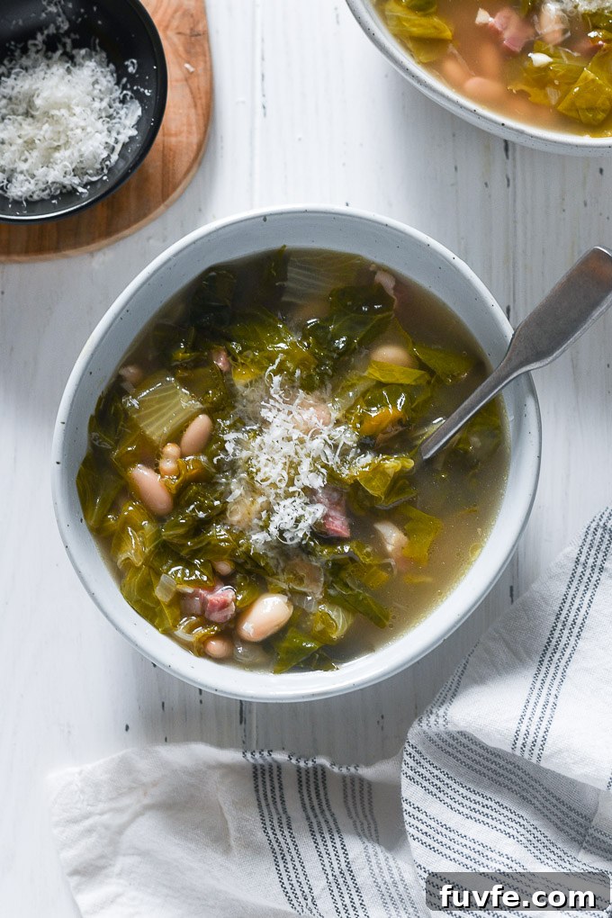 Escarole soup with parmesan cheese on top