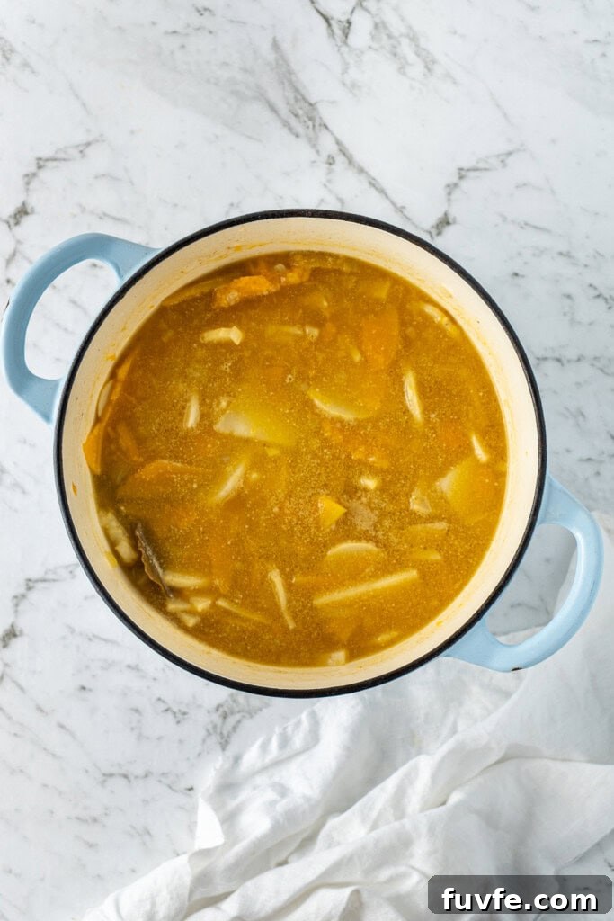 Grandma’s Creamy Pumpkin Soup Recipe 8 Cooking the potatoes and pumpkin in the stock.