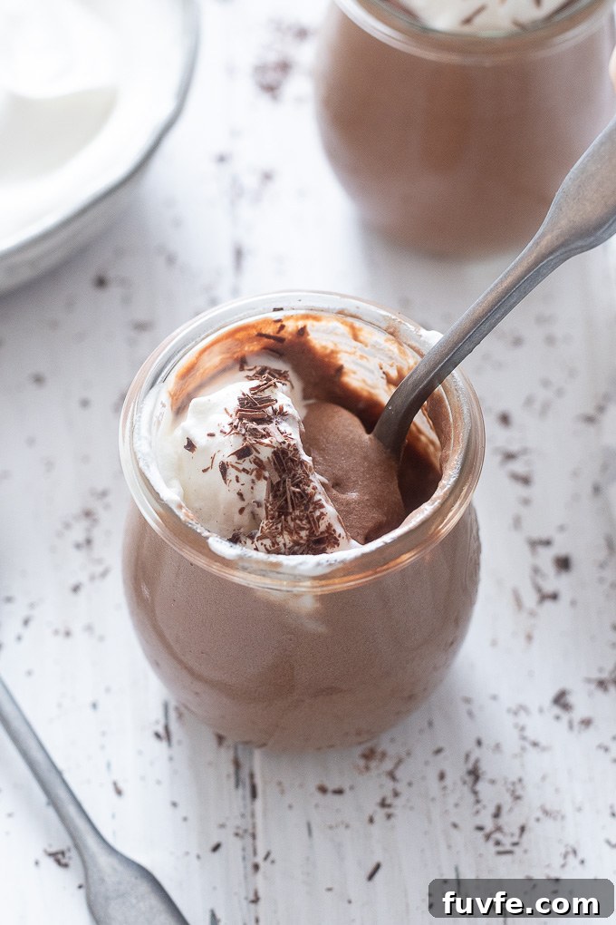 Silky No-Bake Chocolate Mousse Recipe 7 Jar of chocolate mousse with spoon buried inside
