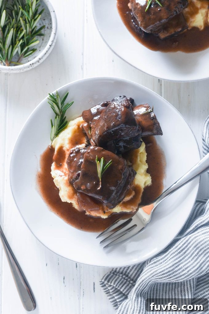 Red wine braised short ribs on a plate with sauce mashed potatoes
