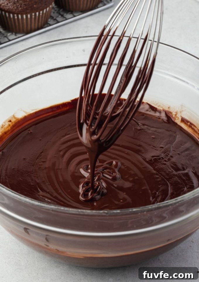 Chocolate Ganache Recipe for Glossy Glaze and Filling 2 Easy chocolate ganache drizzling off a whisk