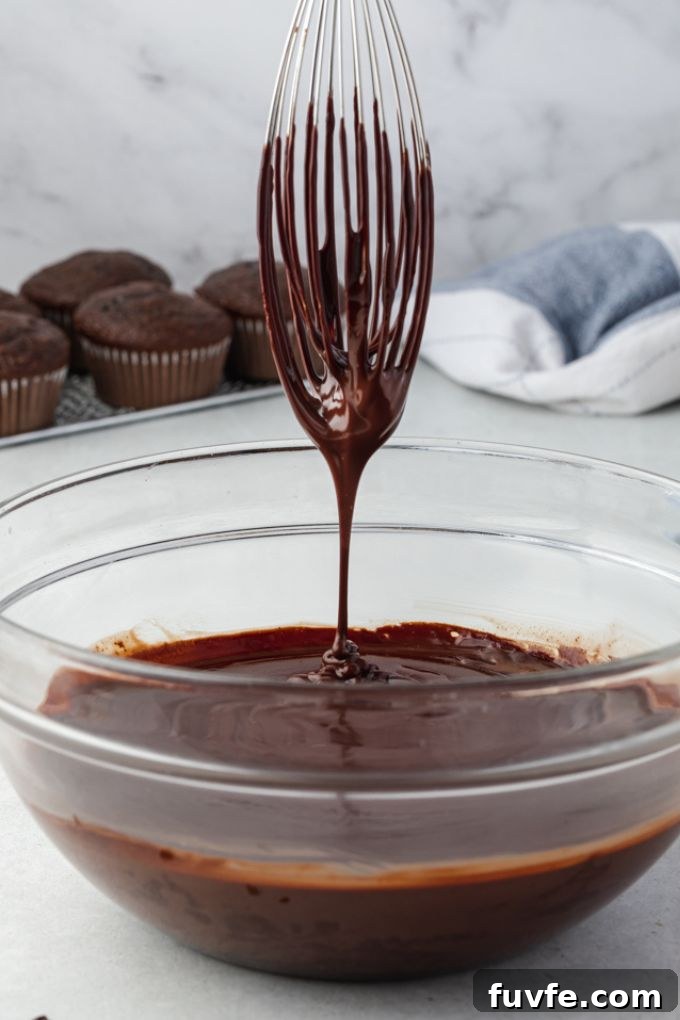 Chocolate Ganache Recipe for Glossy Glaze and Filling 6 Chocolate ganache drizzling off of a whisk